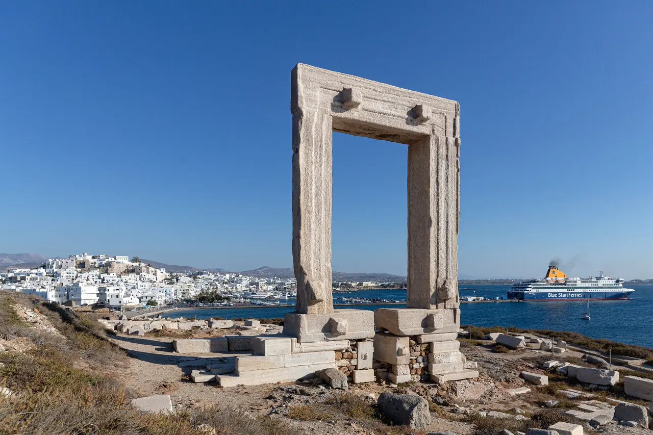 The Portara with the Blue Star Delos ferry in Naxos port